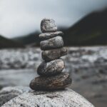 rocks piled on top of each other balancing, indicating balance as a benefit of meditation for introverts